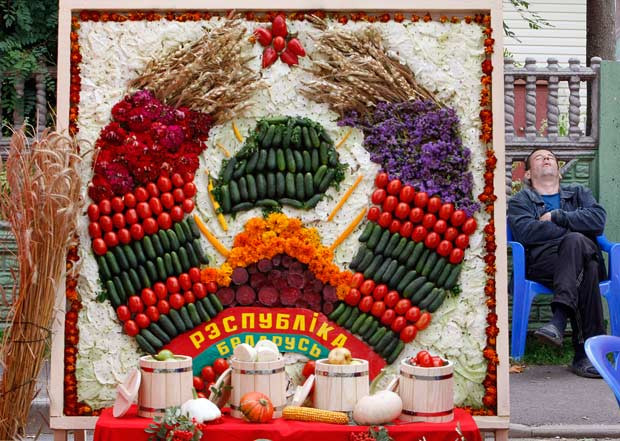 A man sleeps next to a national emblem made from vegetables during an ethnographic festival in the village of Liaskovichi, about 270 km (169 miles) from Minsk, Belarus. During the two-day festival, people gather to remember the old ways of life with different kinds of handicrafts which were used in the last few centuries