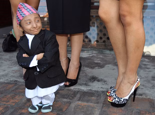 Khagendra Thapa, who is expected to be the world’s shortest man next month when he turns 18, stands with Miss Nepal beauty pageant winners during a news conference in Kathmandu. The Nepal Tourism Board has nominated Thapa and Miss Nepal beauty pageant winners as goodwill ambassadors to promote tourism in Nepal. Thapa will carry the message: 