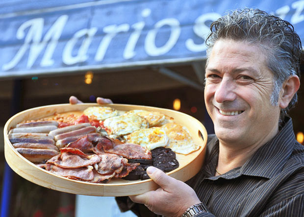A cafe has entered the Guinness World Records book for cooking up the biggest full English breakfast. For £10.95, diners can enjoy 10 rashers of bacon, 10 sausages, 10 eggs, six slices of bread, five slices of black pudding, mushrooms, a tin of beans and a tin of tomatoes. The breakfast, at Mario’s cafe bar in Westhoughton, Bolton, packs in 5,000 calories - nearly twice the recommended daily intake for an average man