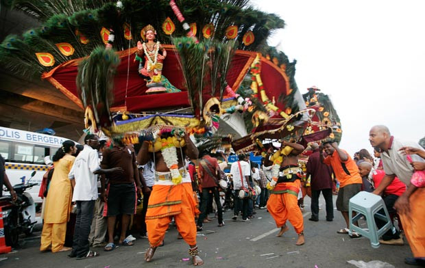 Devotees do penance by carrying heavy ornate structures called kavadis as they walk barefoot up 272 steps to the Batu Caves temple...
