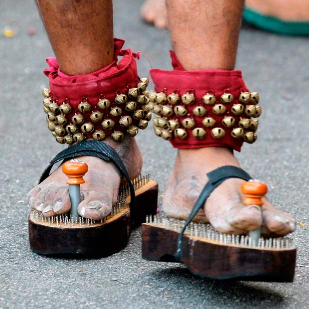 Warning: This gallery contains images of body piercing, which many people will find disturbing. A devotee with metal nail sandals leaves Sri Srinivasa Perumal Temple during the Thaipusam Festival procession in Singapore 