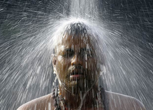 A Hindu devotee performs a ritual bath at the Batu Caves near Kuala Lumpur