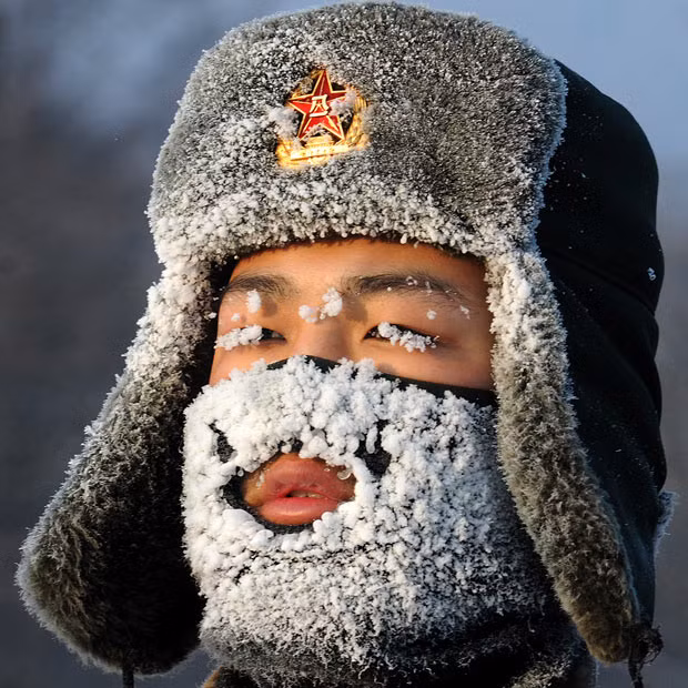 A soldier looks frozen during training, as newly recruited soldiers of the People’s Liberation Army take part in a training session in Yichun, Heilongjiang Province, China...
