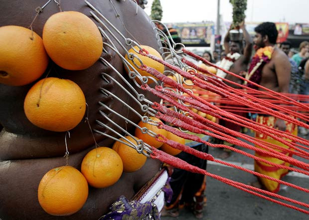 More than one million Hindu devotees have flocked to a Malaysian cave temple to mark a colourful Hindu festival during which they pierce themselves with hooks and skewers