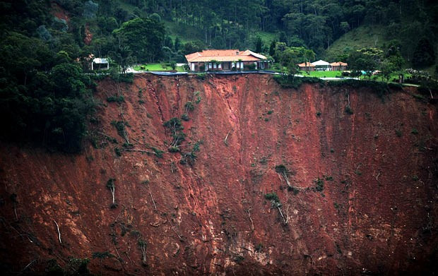 An aerial view of a house at risk following landslides in Poco Fundo, an isolated area near Petropolis, state of Rio de Janeiro, Brazil