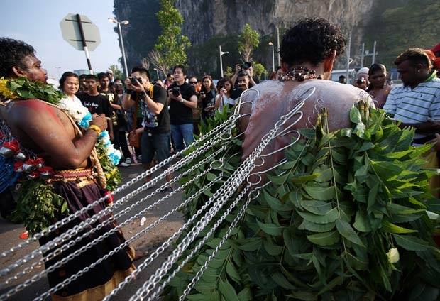 ...while others have their tongues, cheeks and backs pierced with hooks and skewers