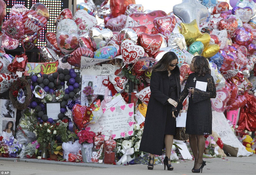 Dressed in black: Two women pause to look at the memorial display before they go into the church to pay their last respects to Whitney Houston Read more: http://www.dailymail.co.uk/news/article-2102985/Whitney-Houston-Funeral-A-galaxy-stars-gather-New-Jersey-say-goodbye-pop-legend.html#ixzz1mnELGRAv