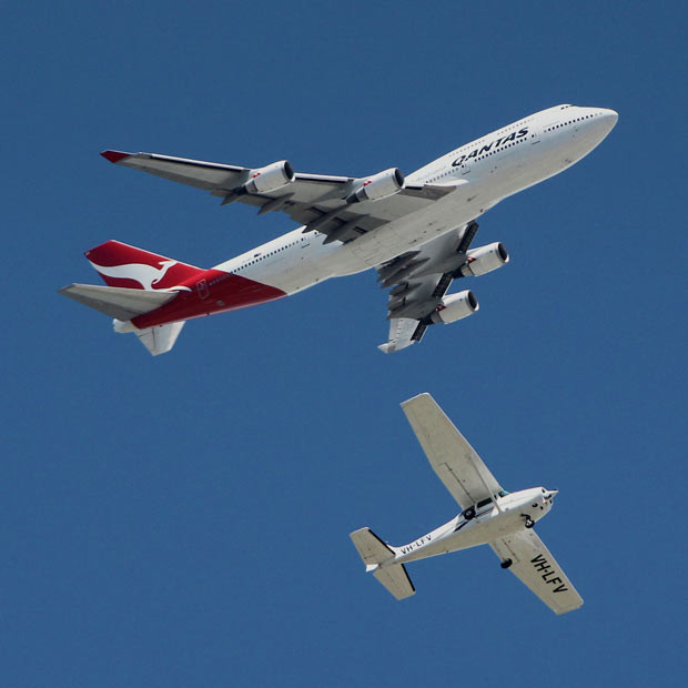 This Boeing 747 looks much too close for comfort to a tiny aeroplane. The passenger jet looms large over the Cessna 172N Skyhawk. Joel Thomas captured the scene over Archerfield Airport, located in the suburbs of Brisbane. He says the Cessna was performing a training flight, doing circuits at 1,000 feet, while the jet was approximately at 3,000ft. Trevor Potter, pilot of the Cessna, says: 