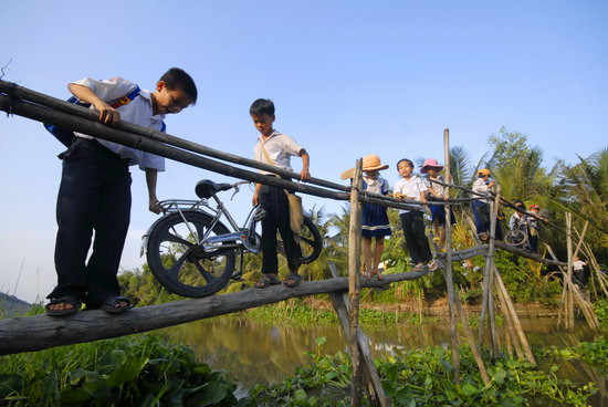 1. Học sinh cấp I ở xã Hòa An, huyện Phụng Hiệp- Hậu Giang phải trèo qua cầu khỉ đến trường