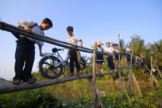 1. Học sinh cấp I ở xã Hòa An, huyện Phụng Hiệp- Hậu Giang phải trèo qua cầu khỉ đến trường