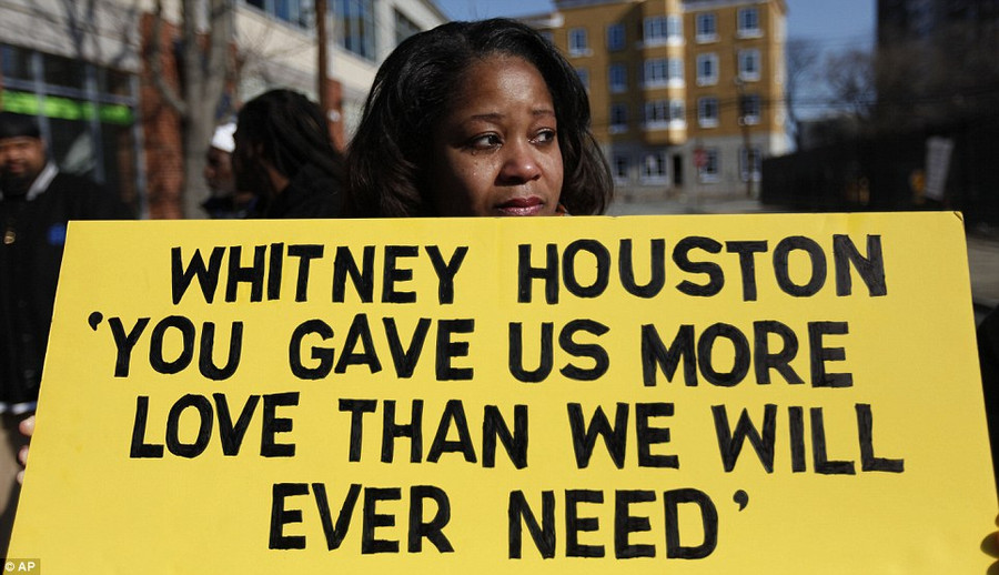 Renee Taylor, of Baltimore, Maryland, stands with a sign a few blocks from the New Hope Baptist Church before the funeral of Whitney Houston where fans gathered to pay their last respects Read more: http://www.dailymail.co.uk/news/article-2102985/Whitney-Houston-Funeral-A-galaxy-stars-gather-New-Jersey-say-goodbye-pop-legend.html#ixzz1mnEb9NJZ