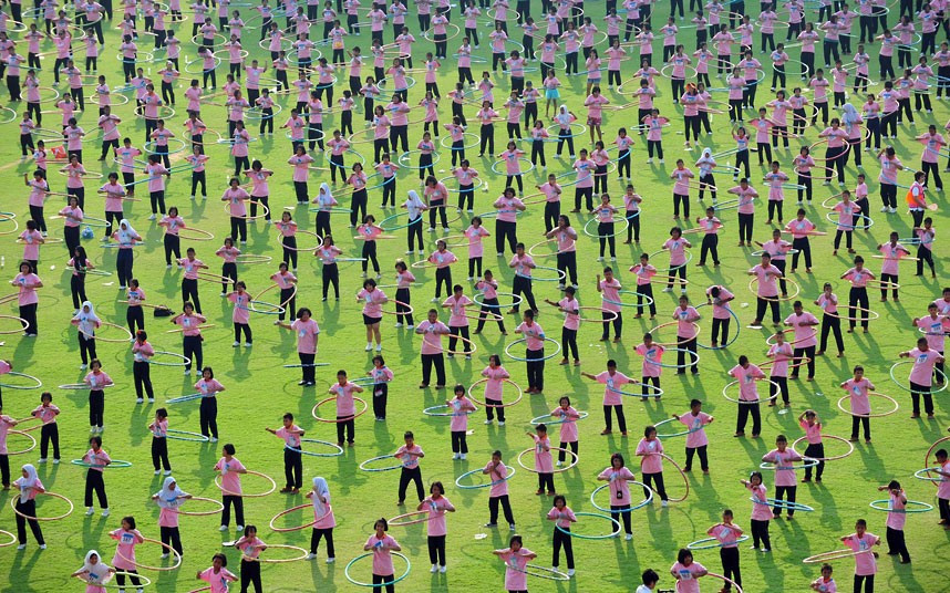 Around 4,500 people take part in a hula hoop competition in an attempt to break the Guinness World Record for most people dancing with hula hoops, at Thammasat University, Pathumthani, Thailand