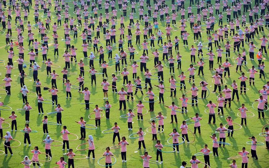Around 4,500 people take part in a hula hoop competition in an attempt to break the Guinness World Record for most people dancing with hula hoops, at Thammasat University, Pathumthani, Thailand