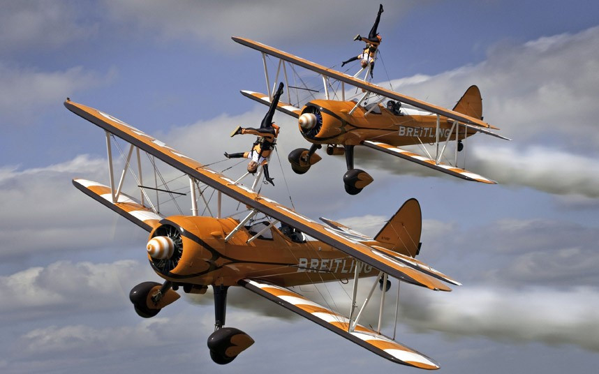 Members of the daredevil Breitling Wingwalkers perform a series of death-defying stunts while strapped to the wings of a plane as it loops and rolls through the sky at 150mph