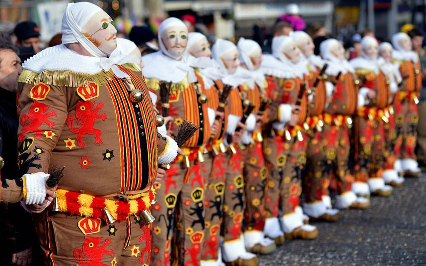 ’Gilles’’ in traditional costumes stand during the carnival in Binche, Belgium