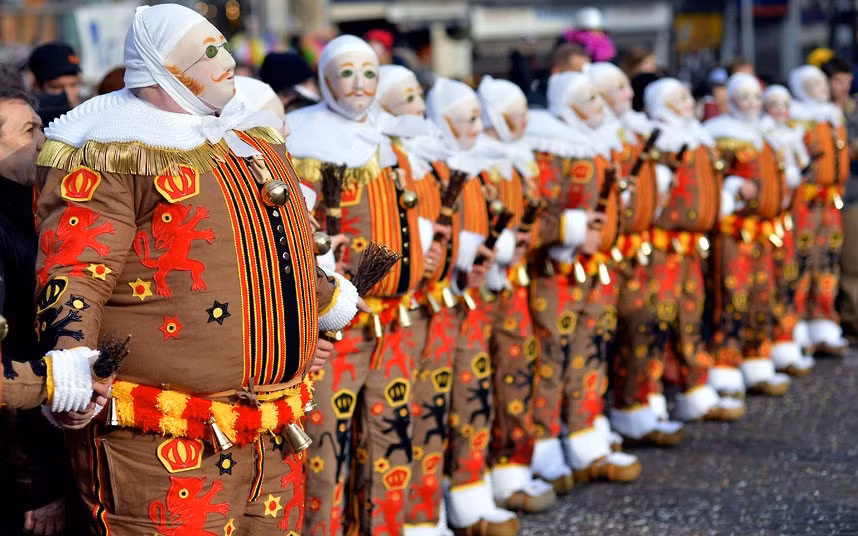 ’Gilles’’ in traditional costumes stand during the carnival in Binche, Belgium