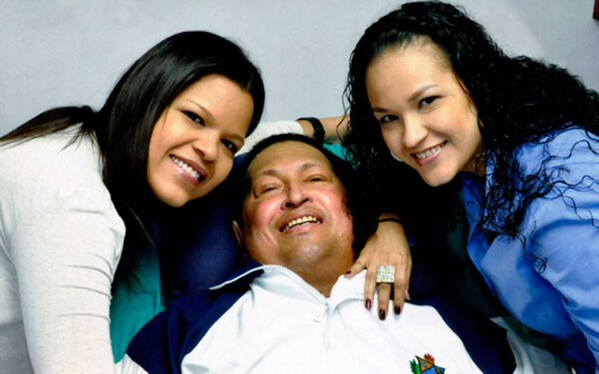 Venezuela’s President Hugo Chavez smiles in between his daughters, Rosa Virginia (R) and Maria while recovering from cancer surgery in Havana. Venezuela’s government published the first pictures of cancer-stricken Chavez since his operation in Cuba more than two months ago.