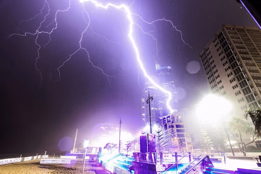A lighting bolt flashes through the night sky and strikes a building in Surfers Paradise, Queensland, Australia, narrowly missing Q1, the largest residential building in Australia. Amateur photographer Luke Wormald was taking shelter from the storm when the bolt struck just 100 metres from him.