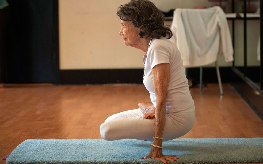 Tao Porchon-Lynch goes through poses in her yoga class in Hartsdale, New York. At 93 years old, she was named the world’s oldest yoga teacher by Guinness World Records.