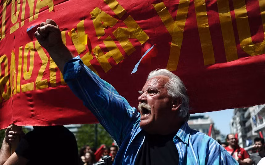 A protester shouts slogans during a May Day demonstration in Athens
