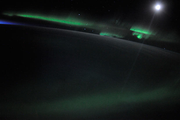 The Earth at night showing the Aurora Australis dancing on a moonlit night, with a new dawn just beyond the horizon. The small pinpoint lights that you see are pixels on the camera’s image sensor blown out by particles of cosmic radiation - one of the hazards of the job out here according to astronaut Douglas Wheelock, who took the picture from the International Space Station