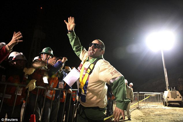 Mario Sepulveda celebrates with rescue workers after becoming the second miner to reach the surface at the San Jose mine in Copiapo Read more: http://www.dailymail.co.uk/news/article-1320045/CHILEAN-MINERS-RESCUE-Back-dead-69-days-trapped-underground.html#ixzz12HvRPf6w