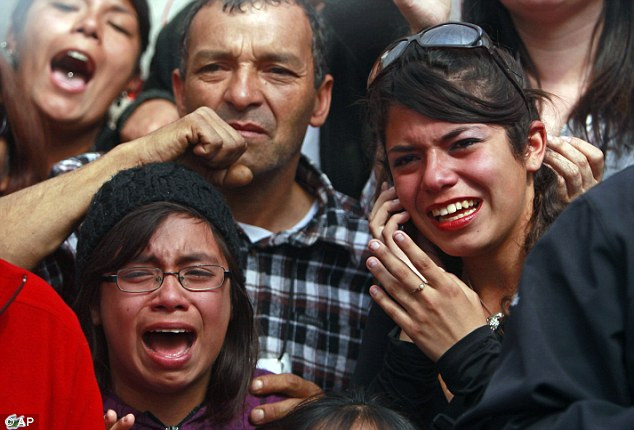 Thank goodness: The oldest rescued miner Claudio Mario Gomez, 59, kneels as he becomes the ninth to exit the rescue capsule Read more: http://www.dailymail.co.uk/news/article-1320045/CHILEAN-MINERS-RESCUE-Back-dead-69-days-trapped-underground.html#ixzz12HvyoyRi