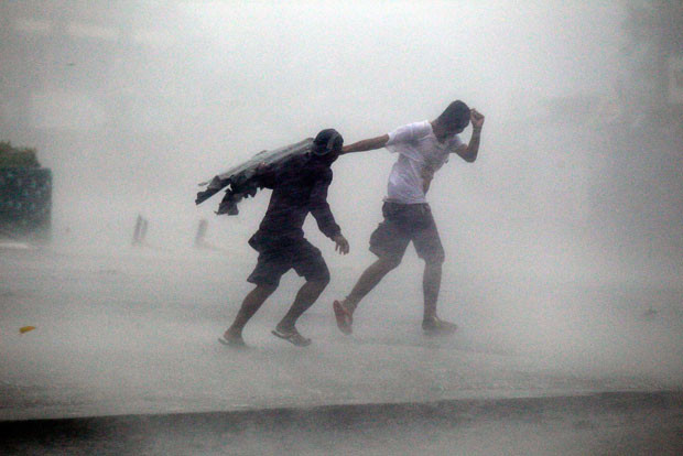 Villagers make their way through Typhoon Megi’s strong winds and rain in Isabela province, northern Philippines
