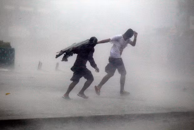 Villagers make their way through Typhoon Megi’s strong winds and rain in Isabela province, northern Philippines