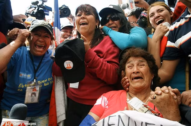 Ecstatic: Relatives of Dario Segovia celebrate as he is brought to the surface Read more: http://www.dailymail.co.uk/news/article-1320045/CHILEAN-MINERS-RESCUE-Back-dead-69-days-trapped-underground.html#ixzz12HuREfNC