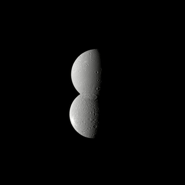 Two of Saturn’s moons - Rhea (bottom) and Dione (top) - appear conjoined in this Cassini spacecraft image. Dione is actually closer to the spacecraft here, but the reflection of the sun and a large crater at its south pole appears to make it blend seamlessly with Rhea. The newly-released image was taken July 27, 2010 at a distance of approximately 1.1 million kilometres (688,000 miles) from Dione and 1.6 million kilometres (994,000 miles) from Rhea