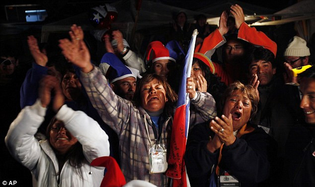 Thank goodness: The oldest rescued miner Claudio Mario Gomez, 59, kneels as he becomes the ninth to exit the rescue capsule Read more: http://www.dailymail.co.uk/news/article-1320045/CHILEAN-MINERS-RESCUE-Back-dead-69-days-trapped-underground.html#ixzz12HvyoyRi