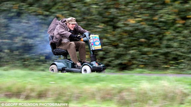 Colin Furze tears along a country lane in his mobility scooter. He hopes to one day hit 70mph Read more: http://www.dailymail.co.uk/sciencetech/article-1320101/The-worlds-fastest-mobility-scooter-Plumber-converts-vehicle-hit-69mph.html#ixzz127IUZqrn