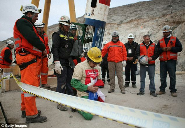 Thank goodness: The oldest rescued miner Claudio Mario Gomez, 59, kneels as he becomes the ninth to exit the rescue capsule Read more: http://www.dailymail.co.uk/news/article-1320045/CHILEAN-MINERS-RESCUE-Back-dead-69-days-trapped-underground.html#ixzz12HvyoyRi