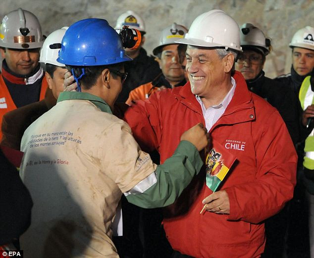 Chilean President Sebastian Pinera (R) as he greets Bolivian miner Carlos Mamani (L) after Mamani was rescued from the collapsed San Jose gold and copper mine Read more: http://www.dailymail.co.uk/news/article-1320045/CHILEAN-MINERS-RESCUE-Back-dead-69-days-trapped-underground.html#ixzz12HwfHiwc
