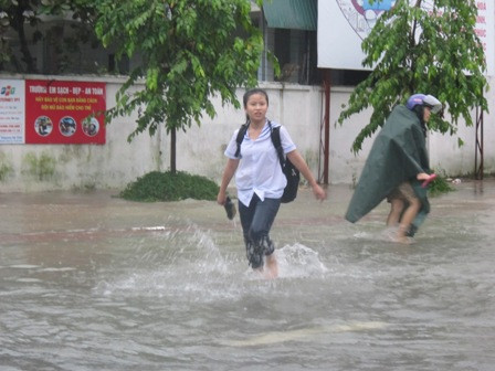 Học sinh, sinh viên lội nước trở về nhà.