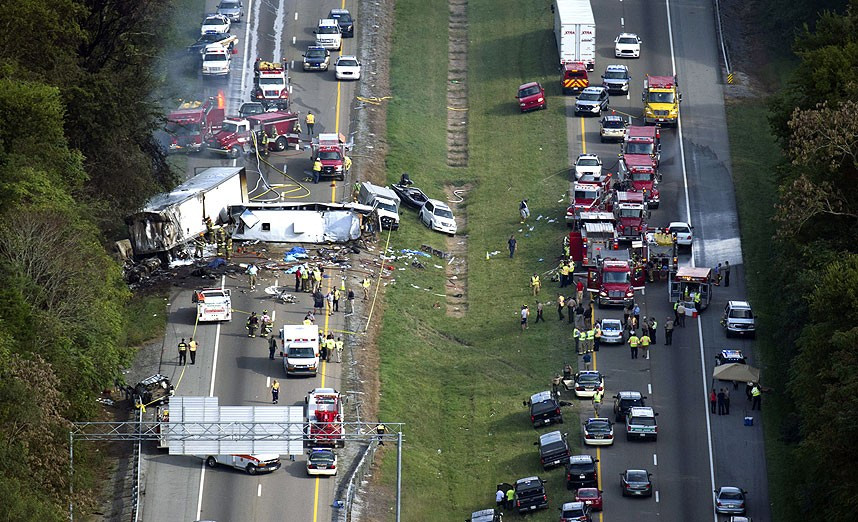 Emergency workers respond to a crash involving a passenger bus, a tractor-trailer and an SUV near Dandridge, Tennessee, USA. Authorities said the bus, carrying members of a North Carolina church group, veered across the highway median and crashed into the other vehicles in a fiery wreck that killed several people.