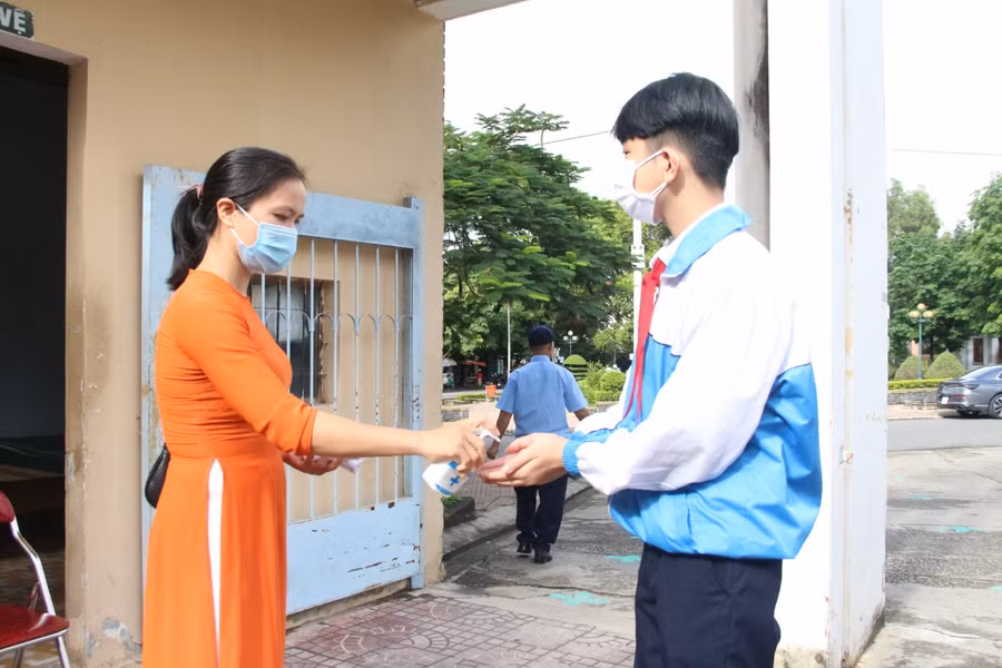 Học sinh được đại diện tham gia Lễ khai giảng đo thân nhiệt, sát khuẩn trước khi vào trường.