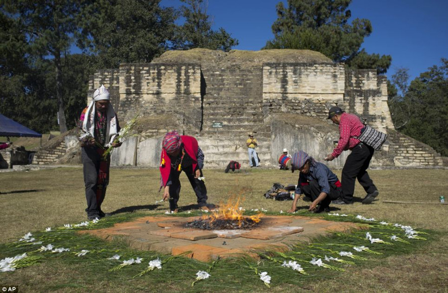 Preparation: Mayan priests place flowers for a ceremony at Iximche archeological site in preparation for the Oxlajuj B’aktun in Tecpan Read more: http://www.dailymail.co.uk/news/article-2251450/End-13th-Baktun-Phew-survived-Mayan-Apocalypse-And-virals-begun-.html#ixzz2Fk1N4W3s Follow us: @MailOnline on Twitter | DailyMail on Facebook