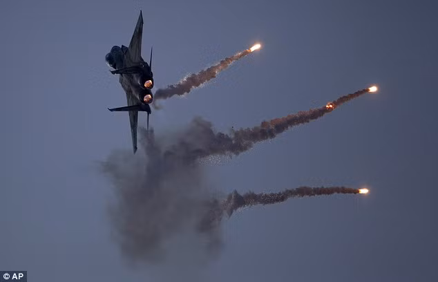 Interceptor: An Israeli Air Force fighter jet releases flares during an acrobatics display Read more: http://www.dailymail.co.uk/news/article-2253830/Israels-Apache-helicopters-stunning-acrobatic-display-mark-gun-graduation.html#ixzz2GIb4HsBU Follow us: @MailOnline on Twitter | DailyMail on Facebook
