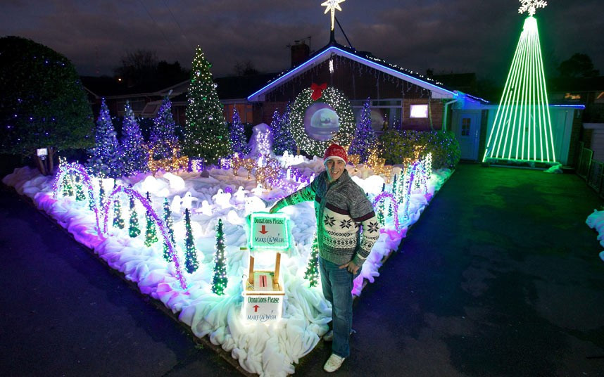Paul Toole outside his house in Wells, Somerset, which he has covered in over 60,000 Christmas lights