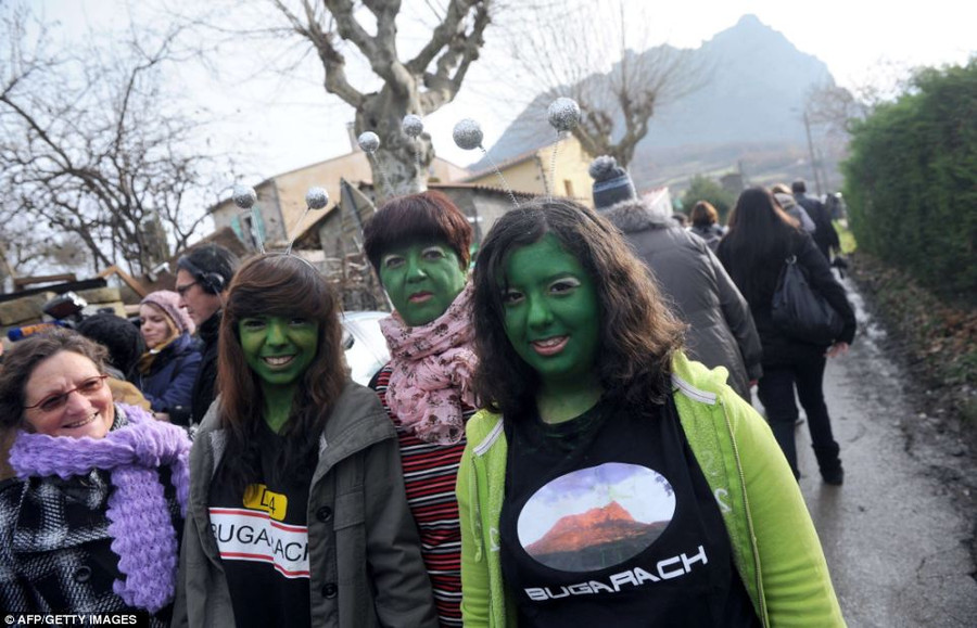 Alien fun: Women with their faces painted in green walk in the French southwestern village of Bugarach, near the 1,231 meter high peak of Bugarach - one of the few places on Earth some believe would be spared Read more: http://www.dailymail.co.uk/news/article-2251450/End-13th-Baktun-Phew-survived-Mayan-Apocalypse-And-virals-begun-.html#ixzz2Fk0b8wRv Follow us: @MailOnline on Twitter | DailyMail on Facebook