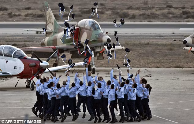 Joy: Israeli pilots throw their hats in the air as they celebrate at their graduation ceremony Read more: http://www.dailymail.co.uk/news/article-2253830/Israels-Apache-helicopters-stunning-acrobatic-display-mark-gun-graduation.html#ixzz2GIbHLAgJ Follow us: @MailOnline on Twitter | DailyMail on Facebook