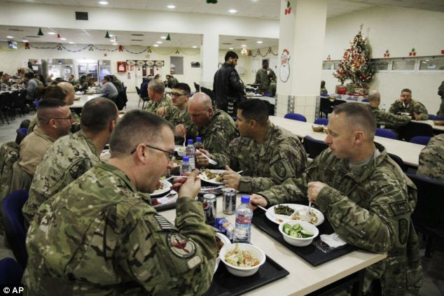 U.S. soldiers and service members with the NATO- led International Security Assistance Force take their dinner at a dinning hall on Christmas Eve at the U.S.-led coalition base in Kabul, Afghanistan Read more: http://www.dailymail.co.uk/news/article-2252960/Its-Christmas-time--Celebrations-kick-world-clocks-strike-midnight.html#ixzz2G1gCLqlW Follow us: @MailOnline on Twitter | DailyMail on Facebook