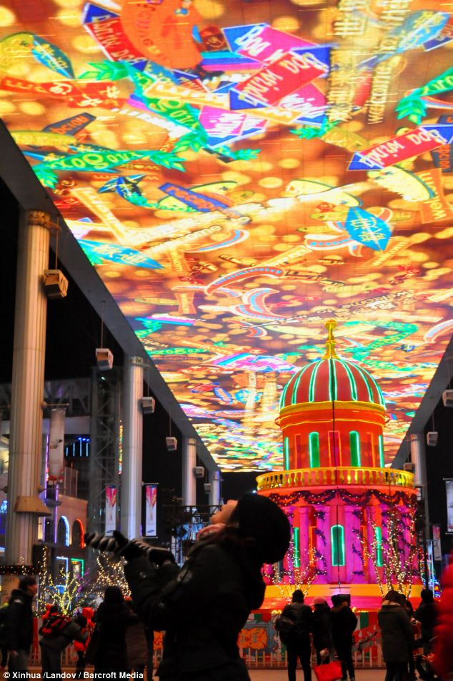 People look at a large screen at The Place, a shopping mall on December Eve in Beijing, China Read more: http://www.dailymail.co.uk/news/article-2252960/Its-Christmas-time--Celebrations-kick-world-clocks-strike-midnight.html#ixzz2G1g35Ij4 Follow us: @MailOnline on Twitter | DailyMail on Facebook