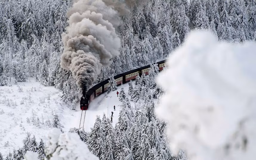 A train on a narrow-gauge railway line makes its way through a winter landscape near Wernigerode, northern Germany 