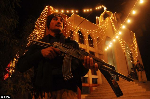 Police stand guard outside a Church as Christians celebrate Christmas, in Peshawar, Pakistan Read more: http://www.dailymail.co.uk/news/article-2252960/Its-Christmas-time--Celebrations-kick-world-clocks-strike-midnight.html#ixzz2G1ffs1hd Follow us: @MailOnline on Twitter | DailyMail on Facebook