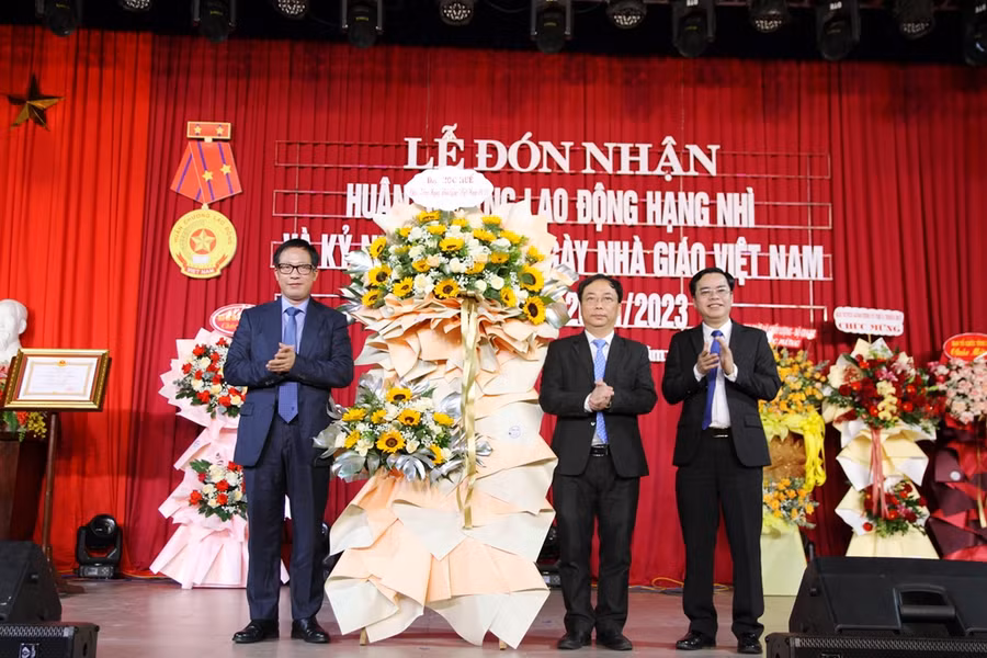 PGS.TS Lê Anh Phương, Giám đốc ĐH Huế (trái) tặng hoa chúc mừng nhà trường.