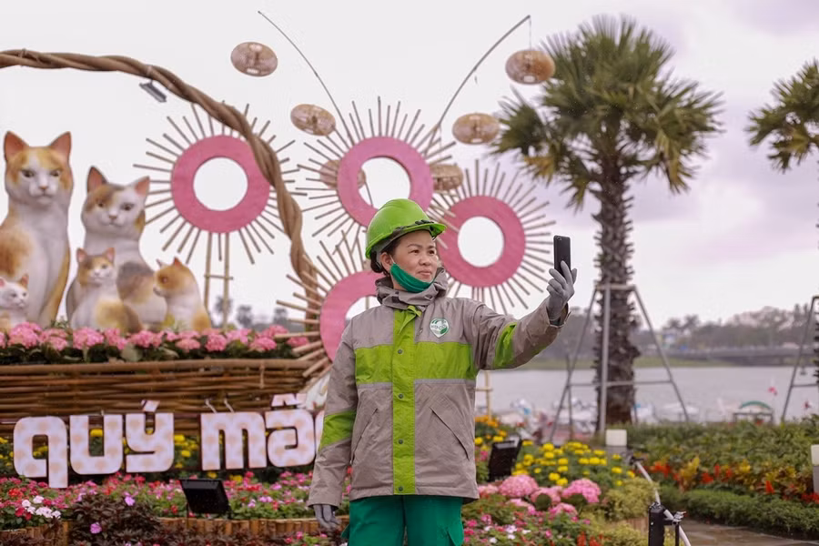 Nữ công nhân tranh thủ lúc làm việc tại đây chụp cùng “Đại gia đình mèo”.