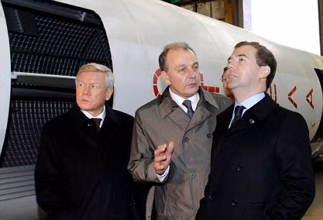 Russian President Dmitry Medvedev (right) listens to chief designer Alexander Leonov (centre) as the head of the Russian space agency Anatoly Perminov (left) looks on, during a visit to the Scientific Engineering production facility